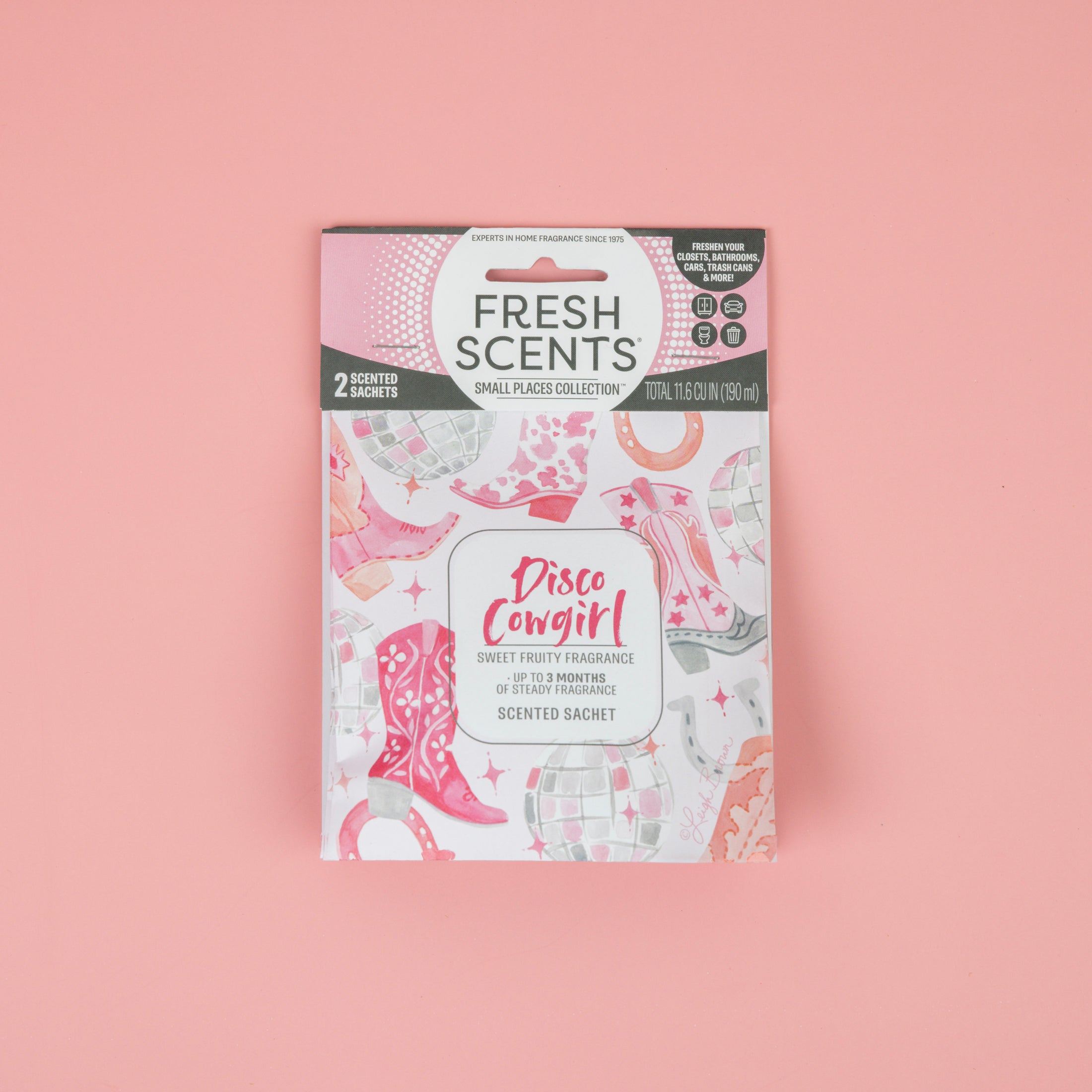 The Fresh Scents Disco Cowgirl - Sachet 2pk features a pink and white package with disco balls, cowgirl boots, and stars. Each pack includes two scented sachets, ideal for adding fragrance to small spaces without a flame.