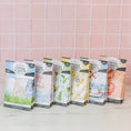 Load image into Gallery viewer, Six Bestsellers Bundle scented sachets by Fast Bundle are displayed in colorful packaging on a white surface with a pink tiled wall behind. This charming set features assorted air freshener scents and unique designs.
