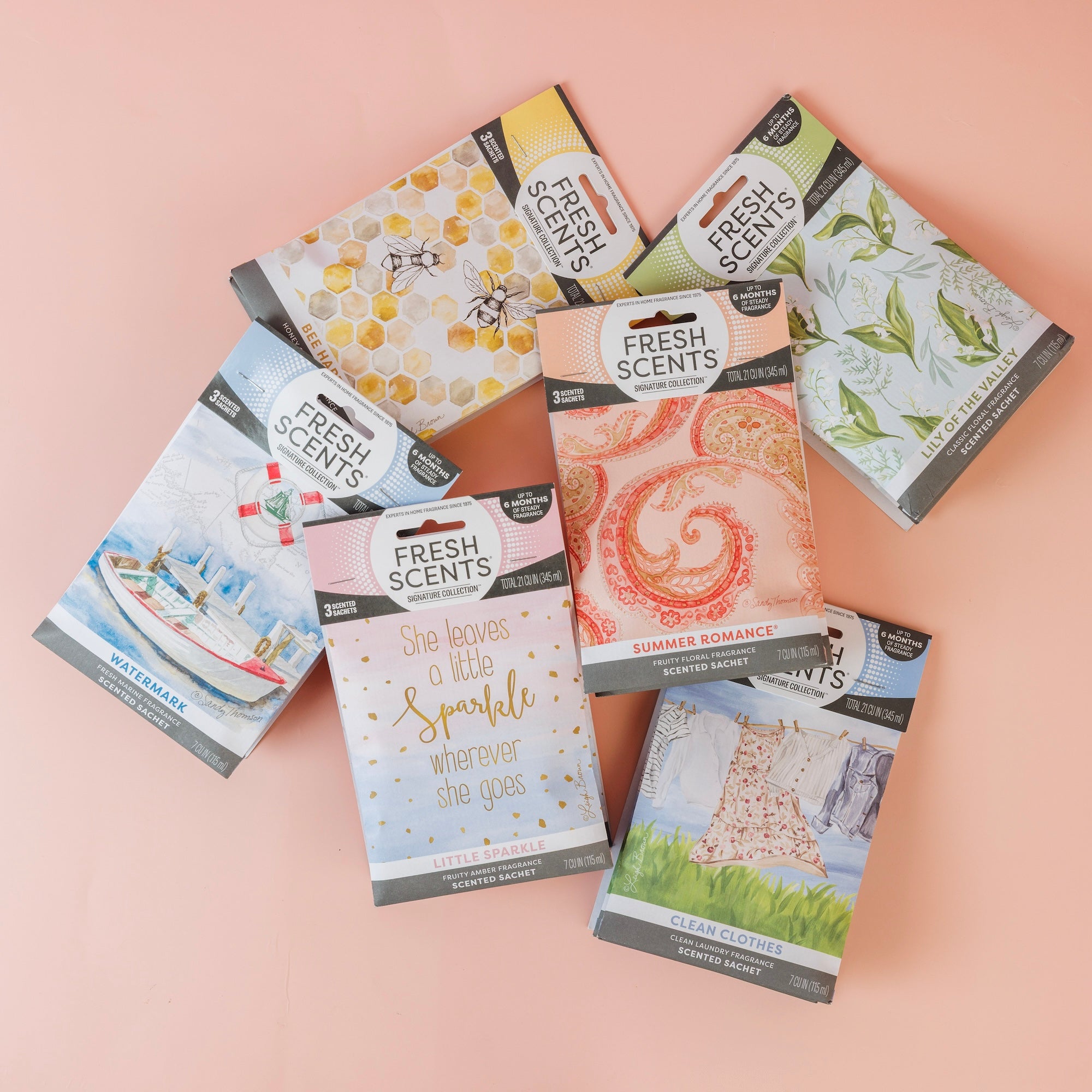 Six Bestsellers Bundle scented sachets by Fast Bundle in colorful packs are displayed on a light pink surface. Scents featured include Watermark, Clean Clothes, Summer Romance, Little Sparkle, and two additional fragrances.