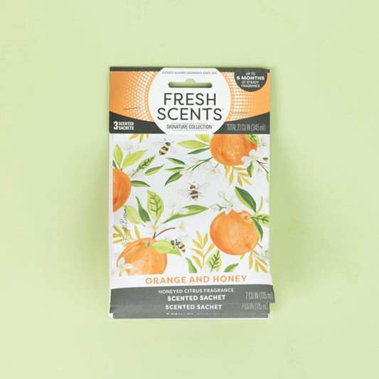 Fresh Scents Orange & Honey - Sachet 3pk features an orange and white design with oranges, green leaves, and bees. Enjoy long-lasting flameless fragrance in any space with this freshener.