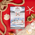 Load image into Gallery viewer, The Fresh Scents Watermark - Sachet 3pk is displayed on a red background with nautical accents—a boat illustration, rope, seashells, sand, compass, and starfish—showcasing this flameless, long-lasting fragrance freshener.
