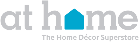 Logo for At Home with the words in light gray lowercase letters; the o in home is replaced by a blue house shape. Below, it says The Home Décor Superstore in smaller gray text.